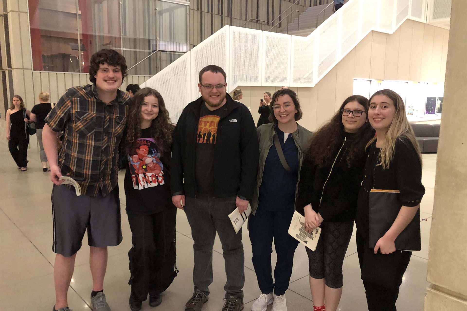 A group of Academy for Twice-Exceptionality students gathered together in a University of Iowa campus building lobby