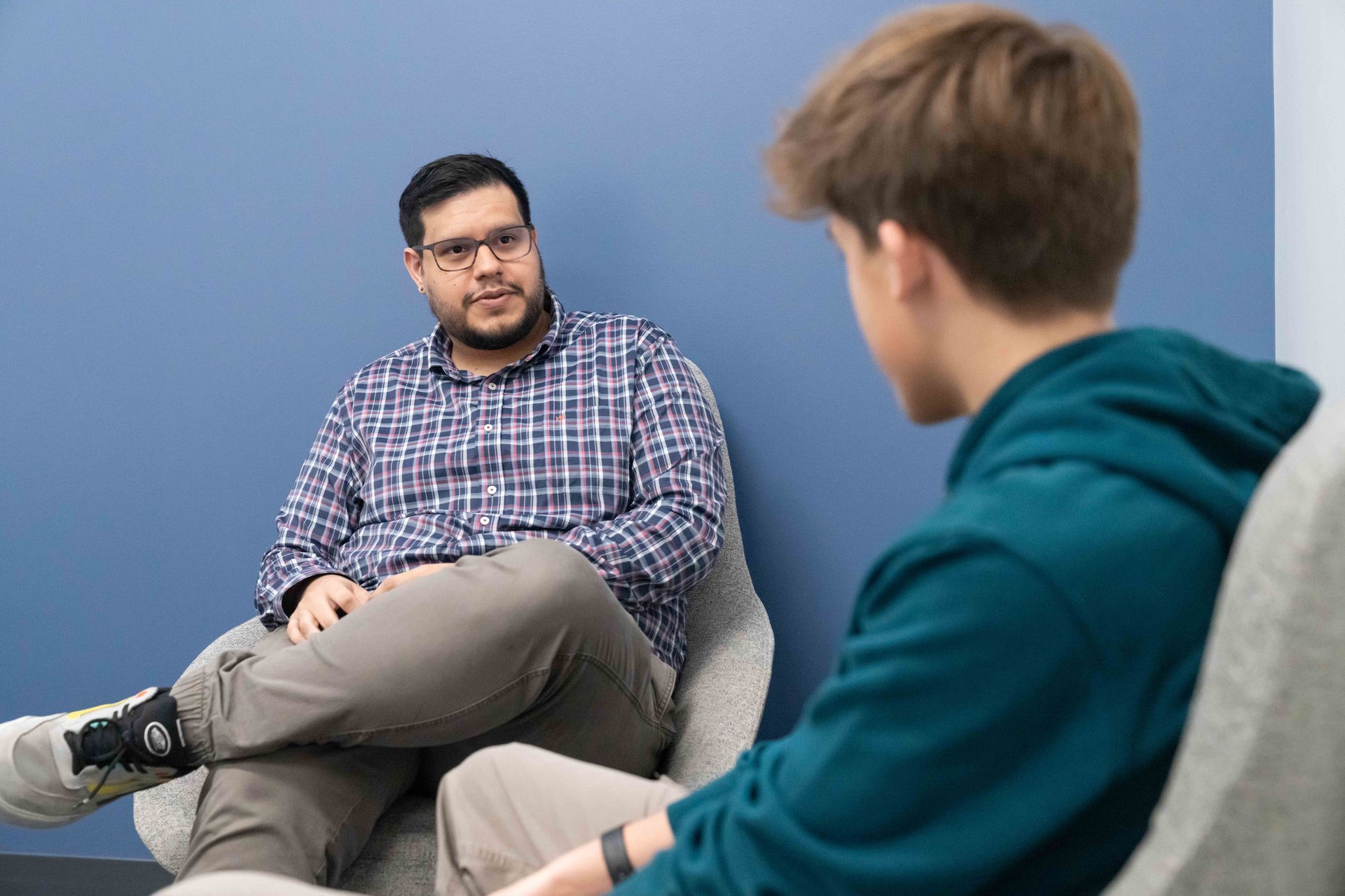 A Belin-Blank Center counselor talking with an adolescent client in a clinic office